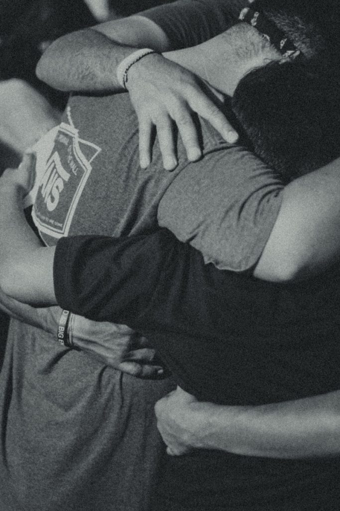 Photo by Josue Escoto grayscale photography of men doing group hug